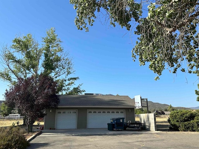 exterior space featuring a mountain view and a garage