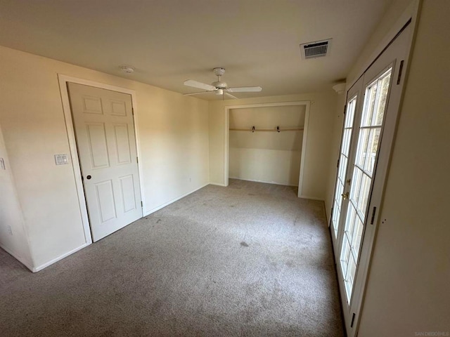 unfurnished bedroom featuring carpet floors and ceiling fan