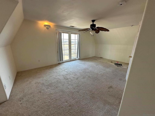 additional living space featuring lofted ceiling, light colored carpet, and ceiling fan