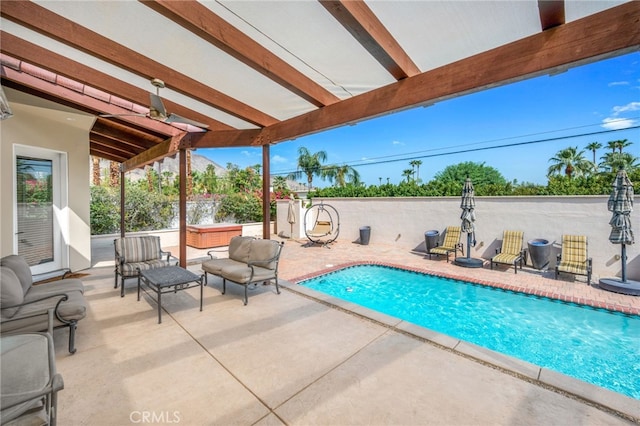 view of swimming pool featuring a patio and a jacuzzi