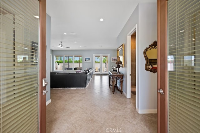 hallway with french doors and light tile patterned flooring