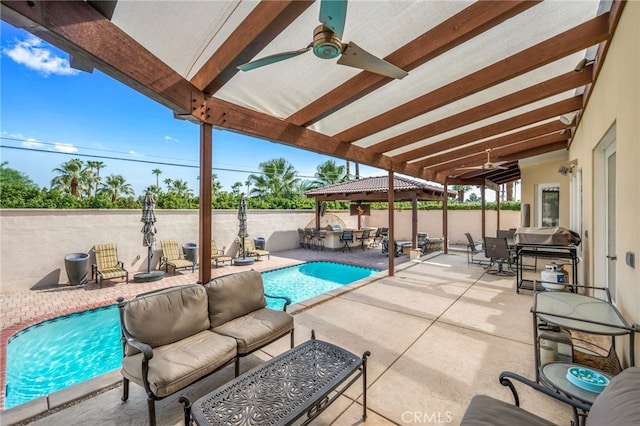 view of swimming pool featuring a patio, ceiling fan, grilling area, and an outdoor living space