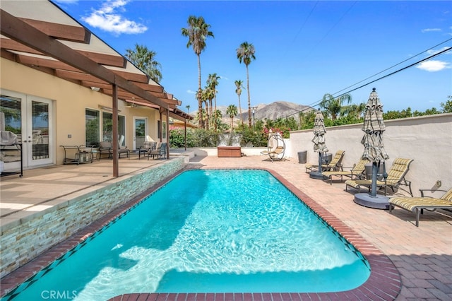 view of pool with a patio and a mountain view