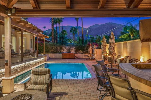 view of swimming pool with a bar, an outdoor fire pit, and a patio