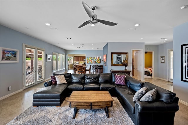 tiled living room with ceiling fan