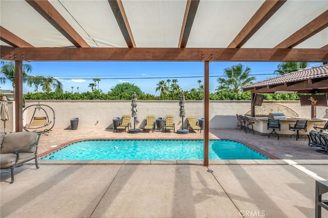 view of pool featuring exterior bar and a patio area