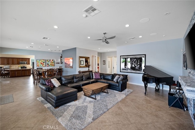 tiled living room with ceiling fan