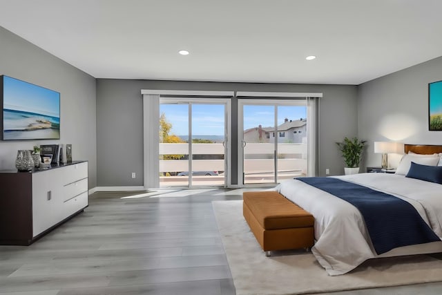 bedroom with access to exterior and light hardwood / wood-style floors