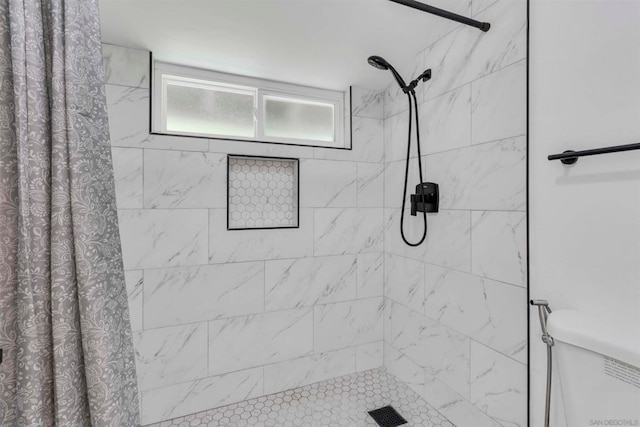 bathroom featuring walk in shower and toilet