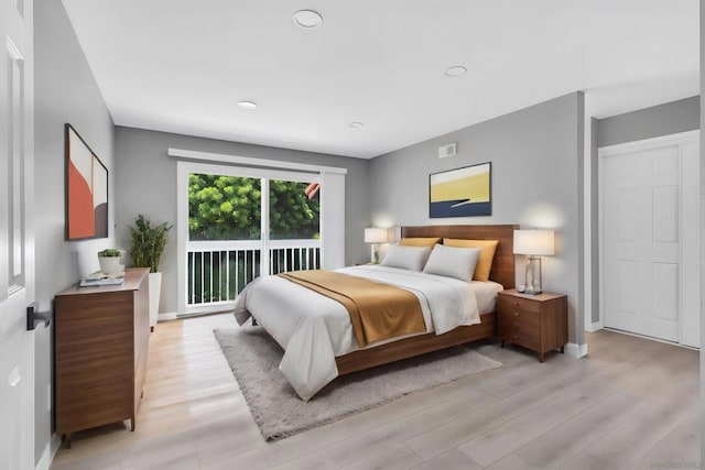 bedroom with access to outside and light hardwood / wood-style floors