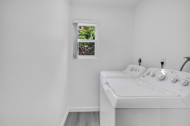 washroom with independent washer and dryer and hardwood / wood-style flooring