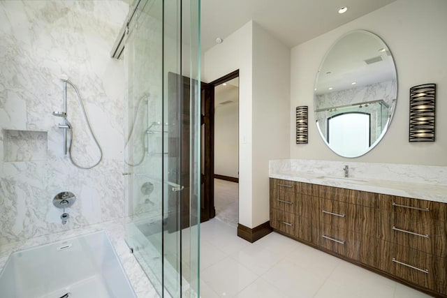 bathroom featuring tile patterned flooring, vanity, and separate shower and tub