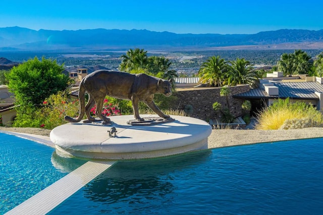 view of pool with a mountain view