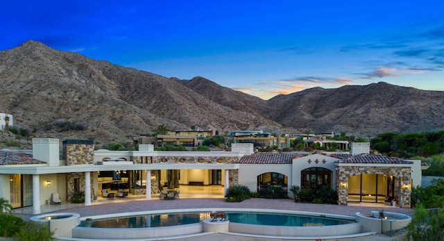 exterior space featuring a mountain view and a patio