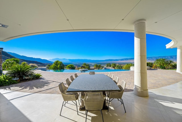 view of patio with a water and mountain view