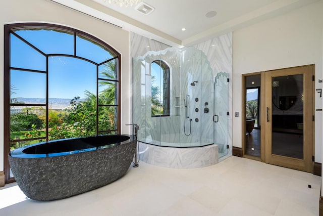 bathroom featuring shower with separate bathtub