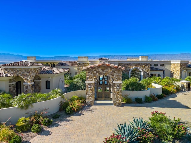 view of front of home with a mountain view and french doors