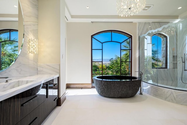 bathroom featuring a chandelier, shower with separate bathtub, and vanity