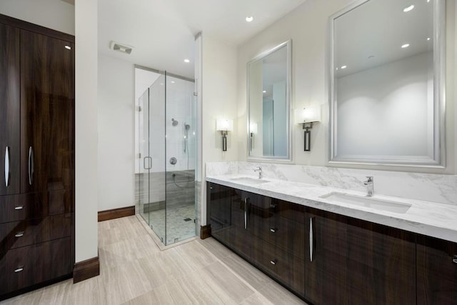 bathroom featuring vanity and an enclosed shower