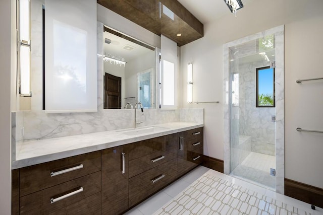 bathroom featuring vanity, tile patterned floors, a shower with door, and backsplash