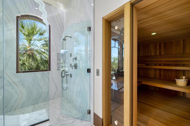 bathroom featuring hardwood / wood-style floors and a shower with shower door