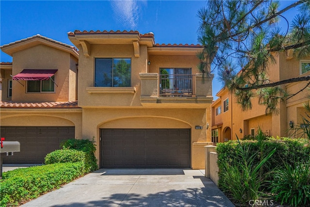 mediterranean / spanish-style house featuring a balcony and a garage