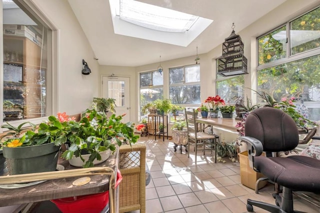 sunroom / solarium featuring lofted ceiling with skylight