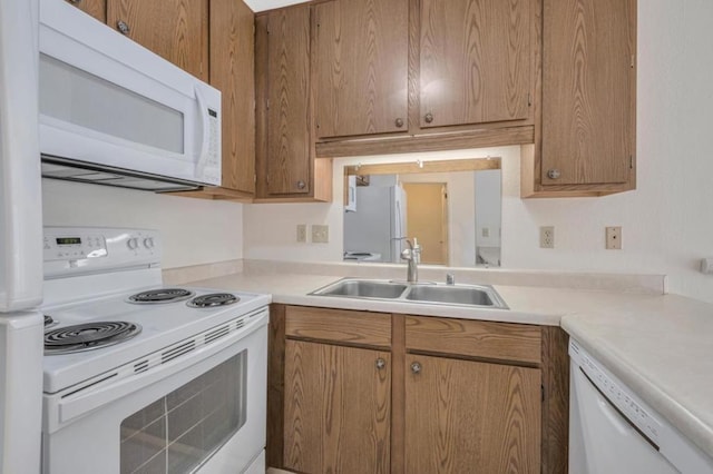 kitchen with sink and white appliances