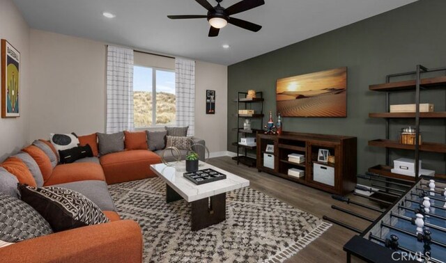 living room featuring wood-type flooring and ceiling fan