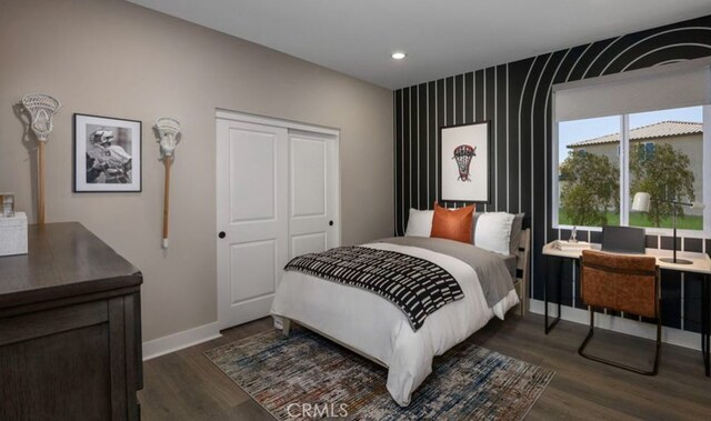 bedroom featuring a closet and dark hardwood / wood-style floors