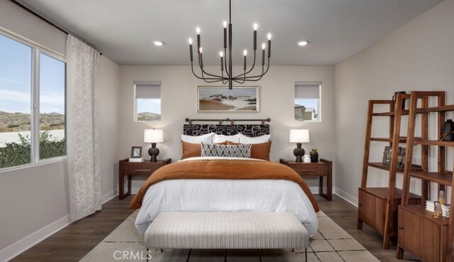 bedroom featuring wood-type flooring, a chandelier, and multiple windows