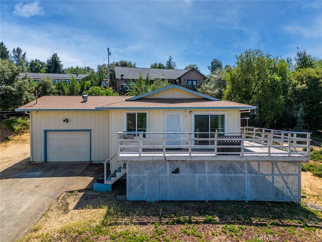 view of front of property featuring a garage and a deck