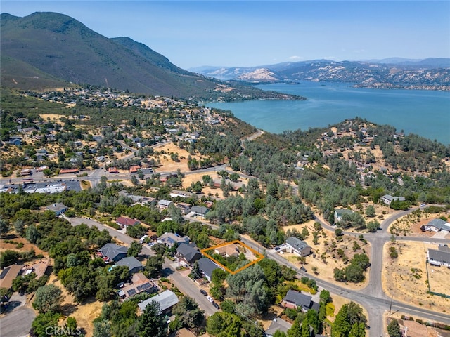 drone / aerial view with a water and mountain view