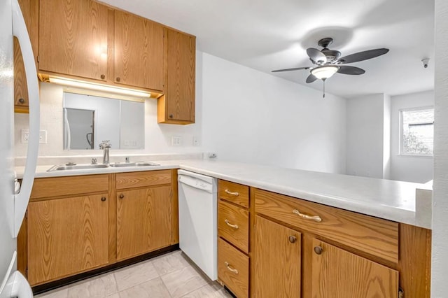 kitchen with white dishwasher, sink, kitchen peninsula, and ceiling fan