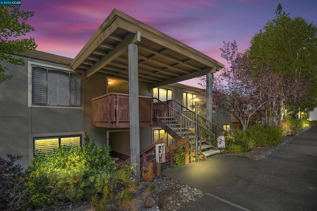 property exterior at dusk featuring covered porch