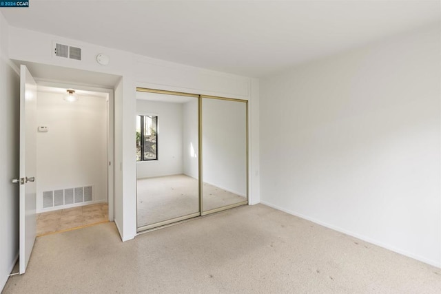 unfurnished bedroom featuring a closet and carpet