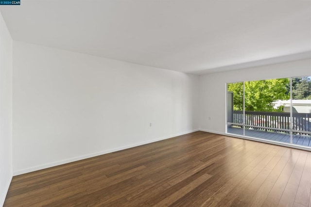 spare room with dark hardwood / wood-style flooring