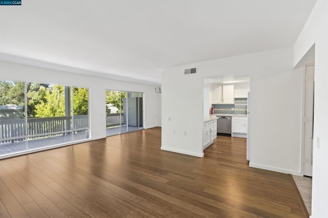 unfurnished living room featuring dark wood-type flooring