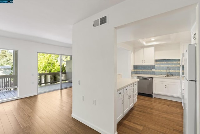 kitchen featuring dishwasher, tasteful backsplash, white cabinets, white refrigerator, and sink