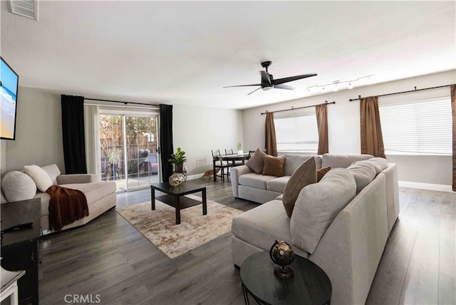 living room featuring rail lighting, hardwood / wood-style floors, and ceiling fan