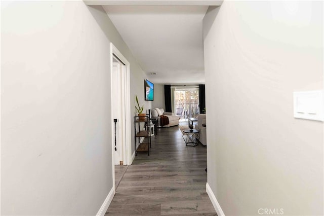 hall with dark hardwood / wood-style floors