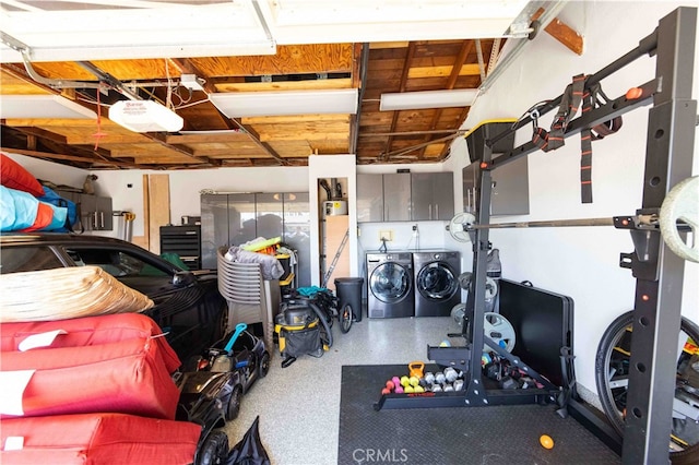 garage with a garage door opener and washer and dryer