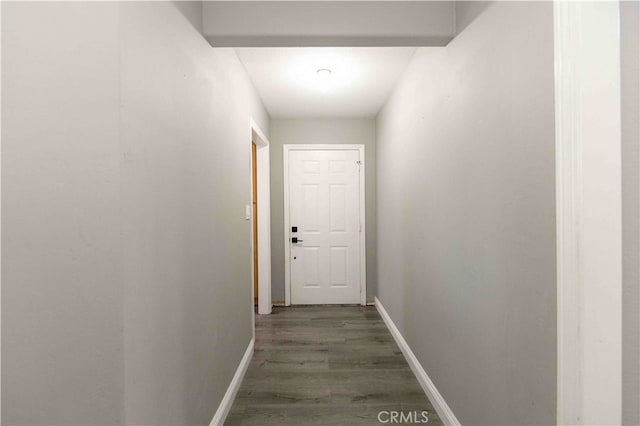 hallway with dark hardwood / wood-style flooring