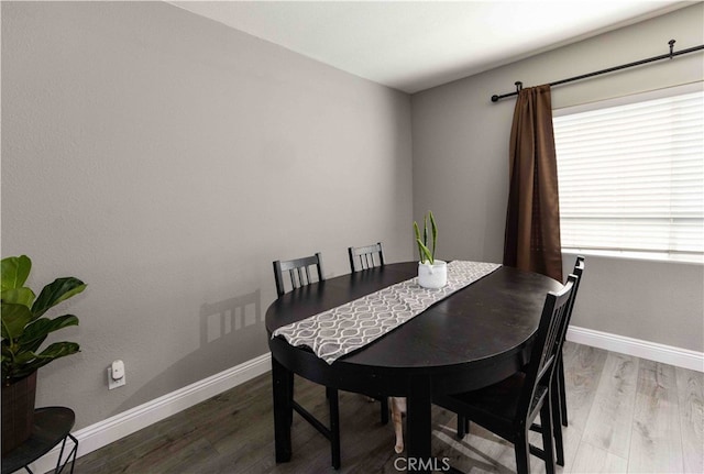 dining space with hardwood / wood-style flooring