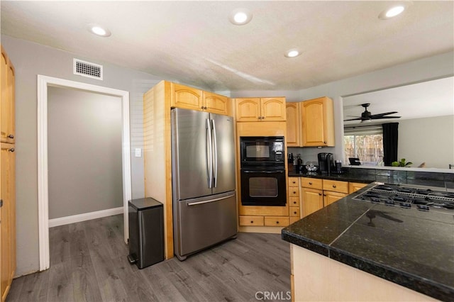 kitchen with ceiling fan, light brown cabinetry, dark wood-type flooring, and black appliances