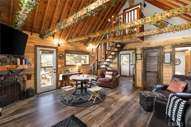 living room with a healthy amount of sunlight, beam ceiling, and dark wood-type flooring