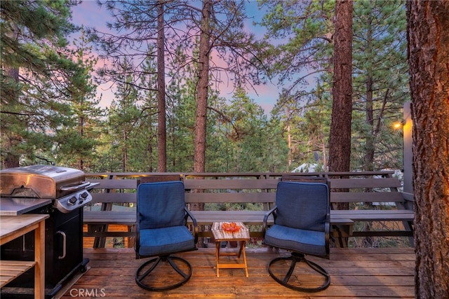 deck at dusk with area for grilling