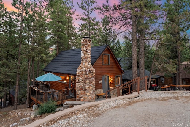 log-style house with a wooden deck