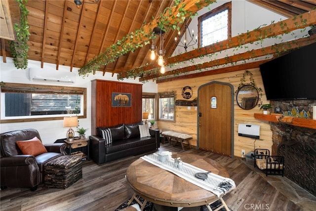 living room featuring a healthy amount of sunlight, wooden walls, an AC wall unit, and hardwood / wood-style flooring