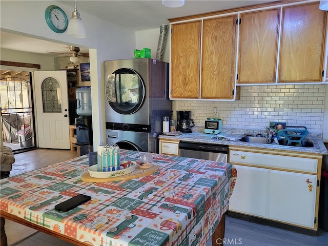 3131 Whispering Pines Rd, Wrightwood, CA 92397 - kitchen featuring stacked washer and clothes dryer, tasteful backsplash, dishwasher, ceiling fan, and pendant lighting